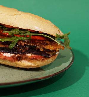 Breaded eggplant, 
balsamic sauce, baked red peppers, green leaves,
and mayonnaise. at Panorama Bar Bazar in Mallorca