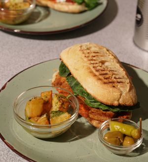 Grilled smoked tofu, dried tomato cream with almonds, and spinach leaves. at Panorama Bar Bazar in Mallorca