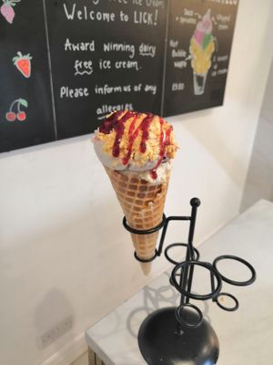 Banana caramel, dark choc cherry, cherry sauce and honeycomb in a standard cone at Lick in Bakewell