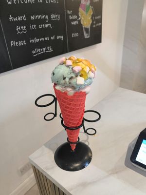 Candyfloss and cookie monster with mango sauce and marshmallows in a strawberry cone at Lick in Bakewell