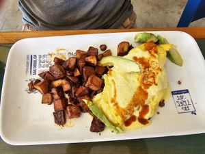 Vegan eggs Benedict with fried potatoes at Fig Tree Cafe in San Diego