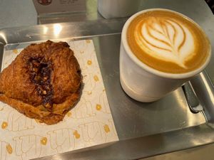 Pain au chocolat and flat white   at Buddy Buddy in Paris