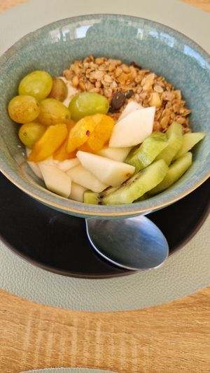 Yogurt with fruits and granola at Oásis da Lagoa in Vila Nova De Santo Andre
