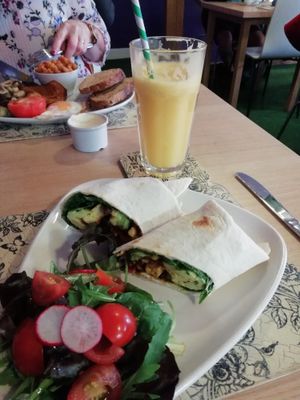 Vegan Breakfast Burrito and fresh orange juice.  at Global Tribe Cafe in Leeds