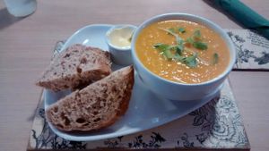 Lentil, carrot and orange soup of the day with bread and vegetable butter at Global Tribe Cafe in Leeds