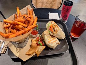 Fake chicken wrap, sweet potato fries, kombucha at Veg Stop in Riga