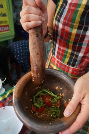 Using the mortar during cooking class at On's Thai Isaan in Kanchanaburi