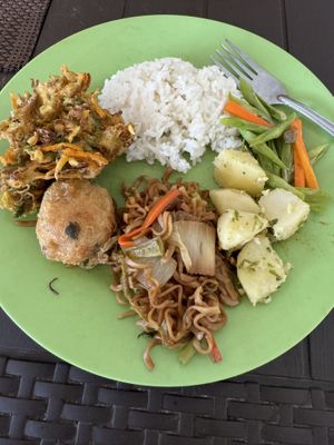 Steamed rice, garlic potatoes, beans, fried potato, fried veggies, and fried noodles   at Warung Rezeki in 