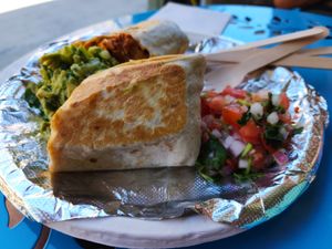 Chimichanga - Griddled flour tortilla filled with black or pinto beans, Mexican rice, corn salad, cheese sauce, and choice of soy protein at El Nopalito Vegan Taqueria in Hollywood