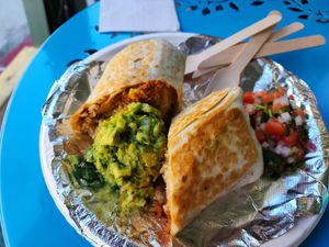 Chimichanga - Griddled flour tortilla filled with black or pinto beans, Mexican rice, corn salad, cheese sauce, and choice of soy protein at El Nopalito Vegan Taqueria in Hollywood