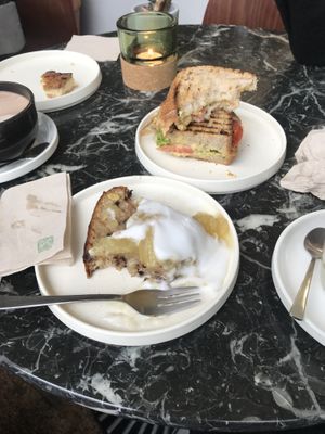 Grilled banana bread with yuzu jam and coconut yogurt , and a vegan sandwich with tomato , salad, chickpeas  at Weird Space Café in Dusseldorf