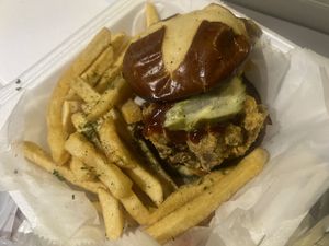 
Crispy Oyster mushrooms on a toasted pretzel bun with house made coleslaw, bbq sauce & fresh garlic pickles. Accompanied with seasoned fries  at Garden of Soul in Bedford