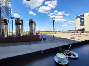 Outdoor view on the terrace and Rhine river at The Coffice Harbour in Cologne