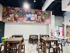 Cozy seating area with vibrant art  at Grandma's Ice Cream & Waffles in Rockville