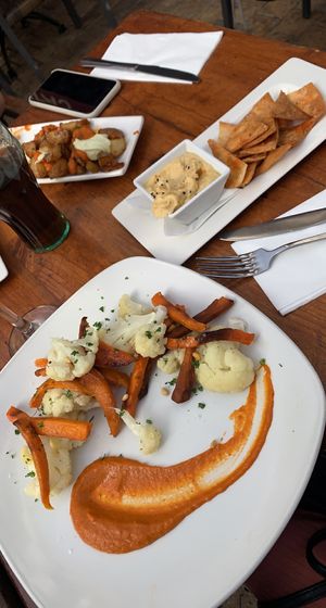 Vegan vegetable bravas and hummus and pitta chips.   at La Plaza in Malaga