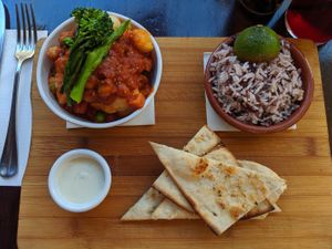 Indian choice... Veg curry, good hit of heat. Wild rice. Tzatziki and flatbread at La Plaza in Malaga