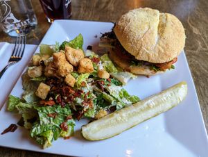 The Downtown Burger with Caesar salad at Alchemist Plant Pub  in Boise