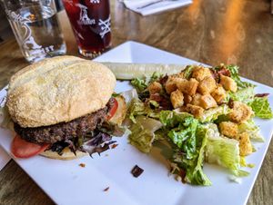 The Downtown Burger with Caesar salad at Alchemist Plant Pub  in Boise