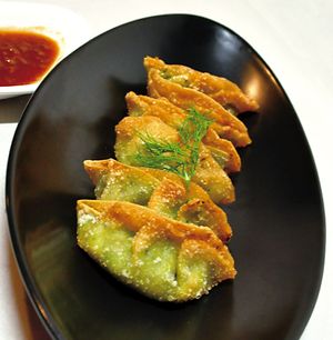 Vegan seasonal potstickers.  Now it is Soymilk gratin & spinach fried potsticker with tomato sauce on side.   at Kick Back Cafe in Tokyo