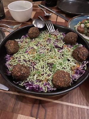 Charred Cabbage Salad: snowy cabbage, allium crunch, sweet onion soubise, carrot ginger dressing + falafel add-on  at Twelvemonth in Burlingame