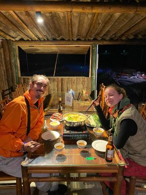 A lovely couple is happily enjoying their steaming hot vegetarian hotpot, savoring the fresh greens and instant noodles with every flavorful bite! at Toàn Mán Restaurant  in Ta Van