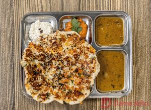 Onion & Tomato Uthappam - Thick Indian pancake made of rice and lentils topped with onions  and tomatoes at Dookan Dosa Bistro in Prague