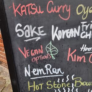 Vegan options on street sign at Bowls in Bruges
