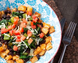 Vegan Scramble - on breakfast potatoes.  Green Peppers, Onion, Black Bean, Spinach, Tomato and Vegan Cheese. at The Atom Bistro and Coffee Bar in Glide