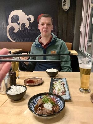 A friends face says it all at Shoku Izakaya in Banff
