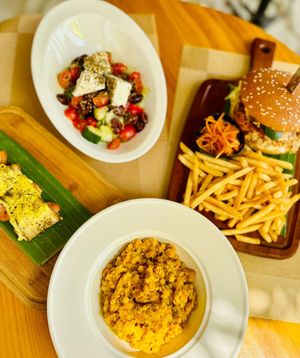 Greek salad with tofu, vegan Po ant eggplant rolls, dhal and vegan “chicken burger”  at Yellow Beach Cafe in Langkawi