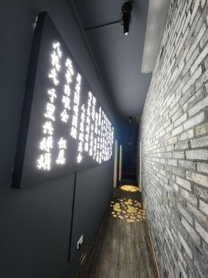 The hallway leading to the restrooms+white room+coat area at Green Light District 红灯区 in Dusseldorf