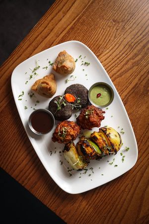 Vegetarian Snacks Platter - Onion Bhaji (vegan), Vegetable Samosa (vegan), Matar Saag ki Tikki (vegan), Tandoori Paneer Shashlik  at Infuse Modern Indian Bistro in St Albans