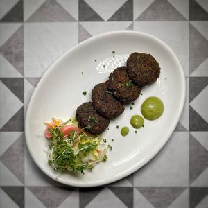 Matar aur Saag ki Tikki - Vegan 
Green peas, spinach, beans potatoes mince, smoked and crisp fried.  at Infuse Modern Indian Bistro in St Albans