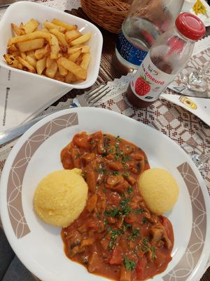 Fries and mushroom stew with polenta at Sergiana in Brasov