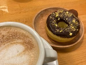 Café con avena, donut con pistacho, y trufa  at Gea The Healthy Bakery in Barcelona