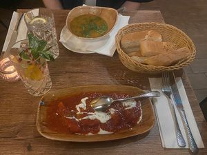 Daal soup, an appetizer with pumpkin, and their delicious “Hewad Water”  at Hewad Restaurant in Munich