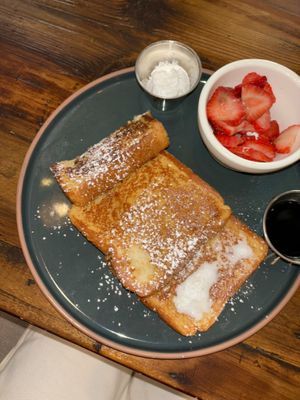 French toast (half a slice eaten) with whipped cream and maple syrup! I asked for all berries as the fruit side (+$1)  at The Ginger Mule in Houston