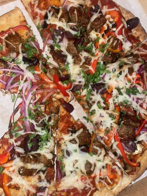 Supreme pizza: marinara, mozzarella, plant based sausage, mushrooms, red bell peppers, red onions & olives  at The Ginger Mule in Houston