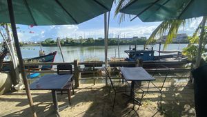 seating by the river  at Com Chay Thien Tam  in Hoi An