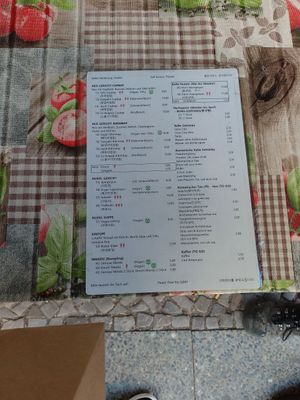 Menu. Vegan green flower is marked at Cafe Ogam in Berlin
