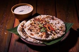 Uttapam is a savory pancakes crispy golden edges and pillowy soft center, topped with veggies and served with coconut chutney or piping sambar. at Jagdish Farshan in Irving