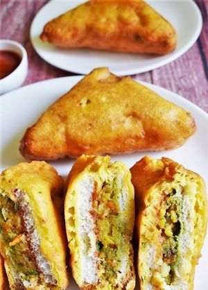 Bread pakoda is a popular Indian snack made by dipping bread slices in spiced gram flour batter, deep-frying until crispy and golden brown, and serving with chutneys. at Jagdish Farshan in Irving