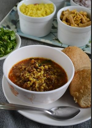 Misal Pav is a popular Maharashtrian street food dish made with a spicy curry of sprouted lentils (misal) topped with crunchy mix-ins and served with bread (pav). at Jagdish Farshan in Irving