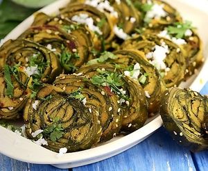 Patra is a Gujarati snack made with colocasia leaves coated with a spiced chickpea flour batter, steamed, and then pan-fried until crispy. at Jagdish Farshan in Irving