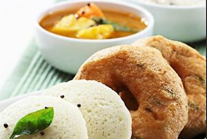 Idli Vada combo is a popular South Indian breakfast dish consisting of steamed rice-lentil cakes (idli) and deep-fried lentil fritters (vada), served with chutney and sambar. at Jagdish Farshan in Irving