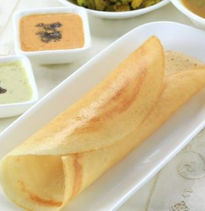 Plain Dosa is thin and Crispy golden crepe made with fermented rice and lentil batter and served with tangy sambhar and coconut chutney. at Jagdish Farshan in Irving
