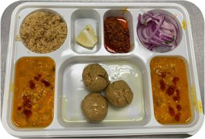 Dal Baati Churma is a  super delicious, Dal, Deep fried baati and Semi Sweet Churma. at Jagdish Farshan in Irving
