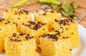Nylon Khaman is a light, spongy Gujarati snack made from fermented gram flour batter, steamed and tempered with spices, and served with green chutney. at Jagdish Farshan in Irving