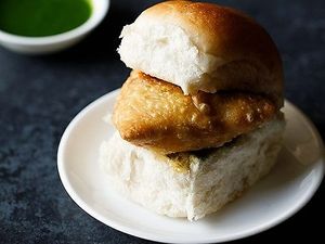 Samosa pav is a Mumbai street food that consists of a spicy samosa sandwiched between a soft bread roll (pav) and served with chutneys and fried green chilies. at Jagdish Farshan in Irving