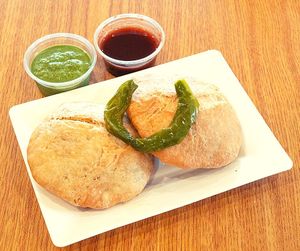 Kachori is a deep-fried Indian snack consisting of a crispy pastry shell filled with a spicy mixture of lentils, peas, or potatoes. at Jagdish Farshan in Irving